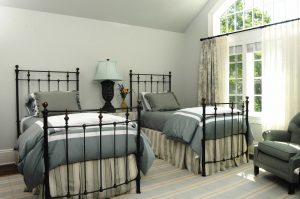 photo of bedroom with twin iron beds