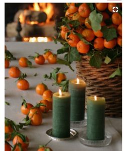photo of candles and oranges in a basket