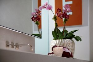 detail photo of orchids on contemporary bathroom sink