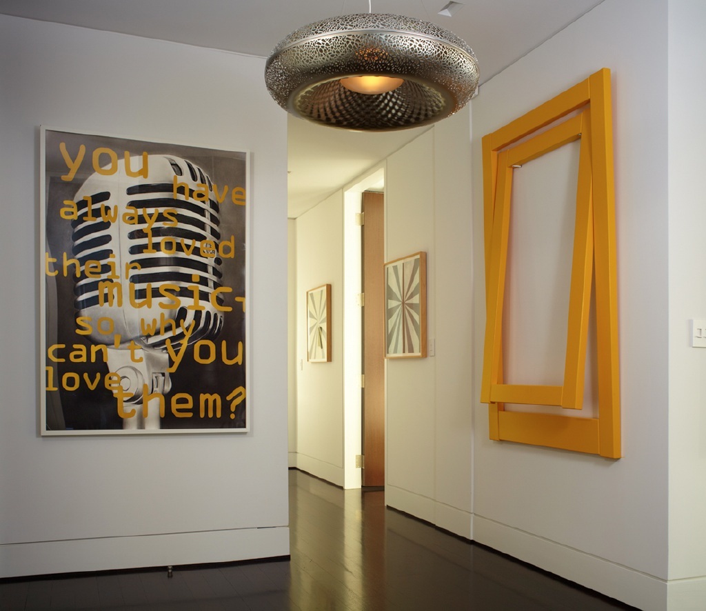 photo of contemporary entryway with large poster, art assemblage and circular overhead light fixture