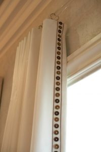 detail photo of custom window treatment with button edging
