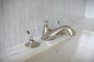 detail photo of bathroom sink with glass handles