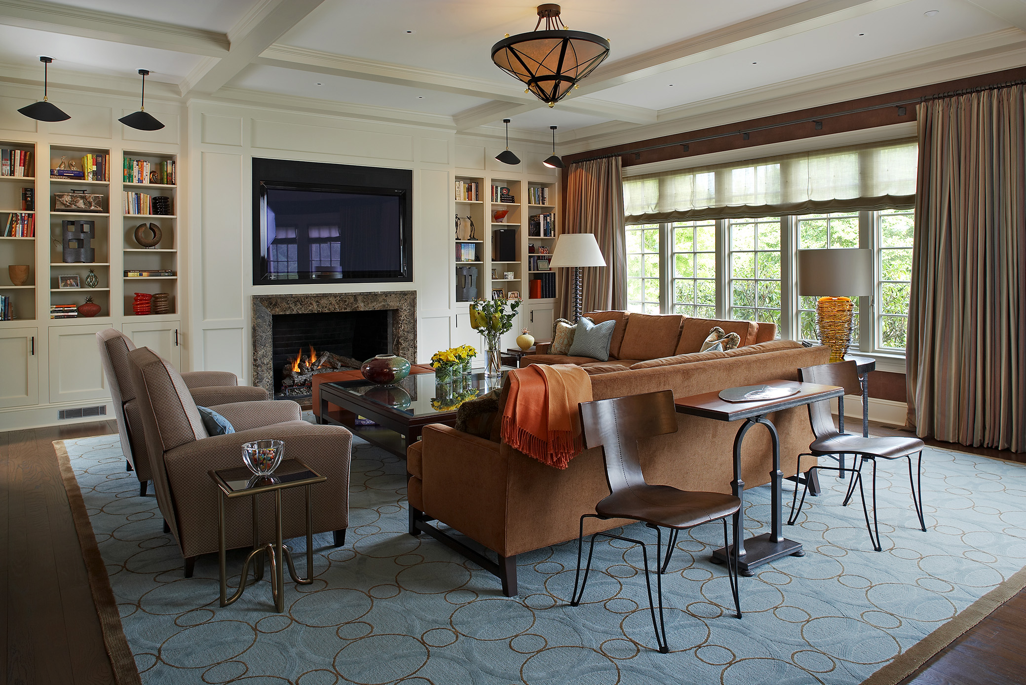 Photo of family room with seating around central coffee table and fireplace