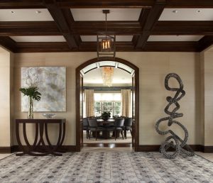 photo of front hallway with abstract sculpture and view of dining room