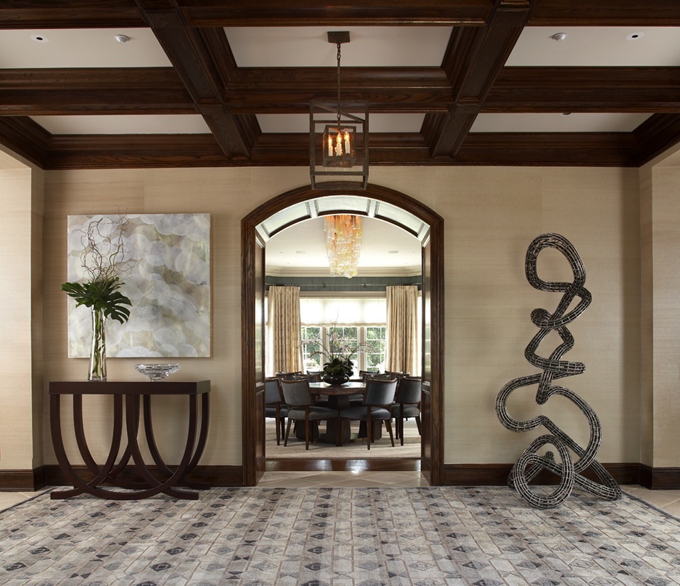 photo of front hallway with abstract sculpture and view of dining room