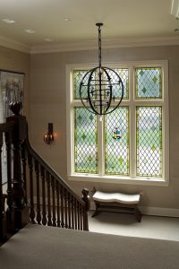 photo of stairwell with round metal hanging light fixture