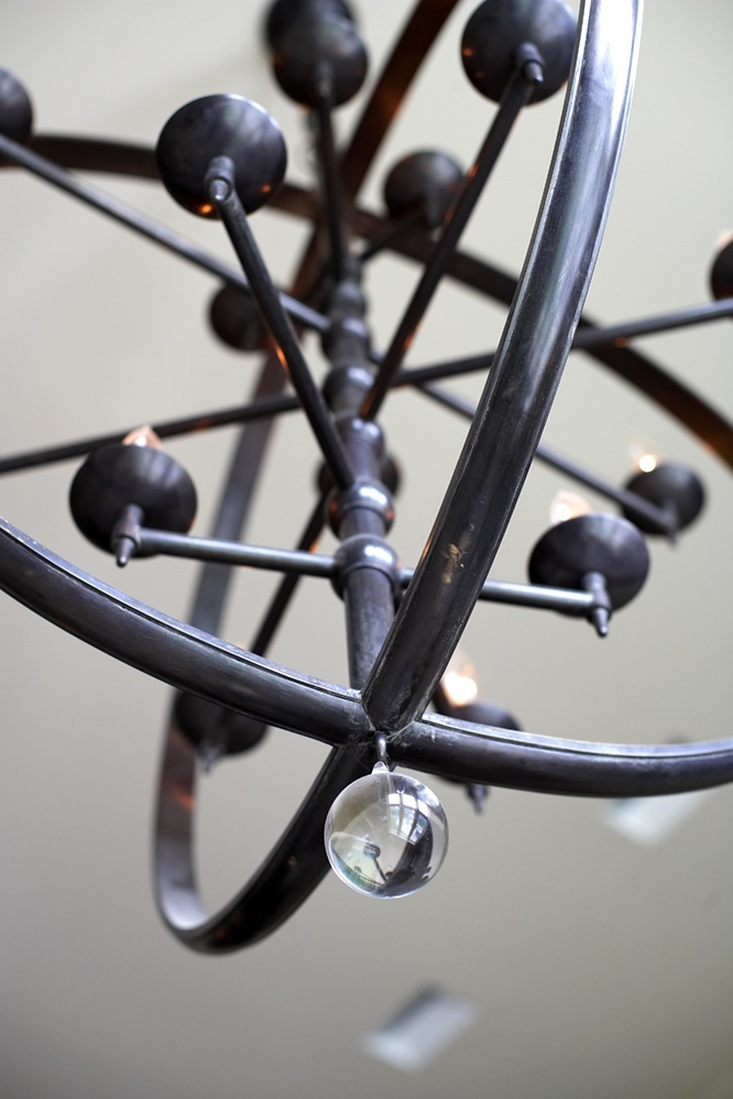 photo of metal sculpted light fixture with glass bead