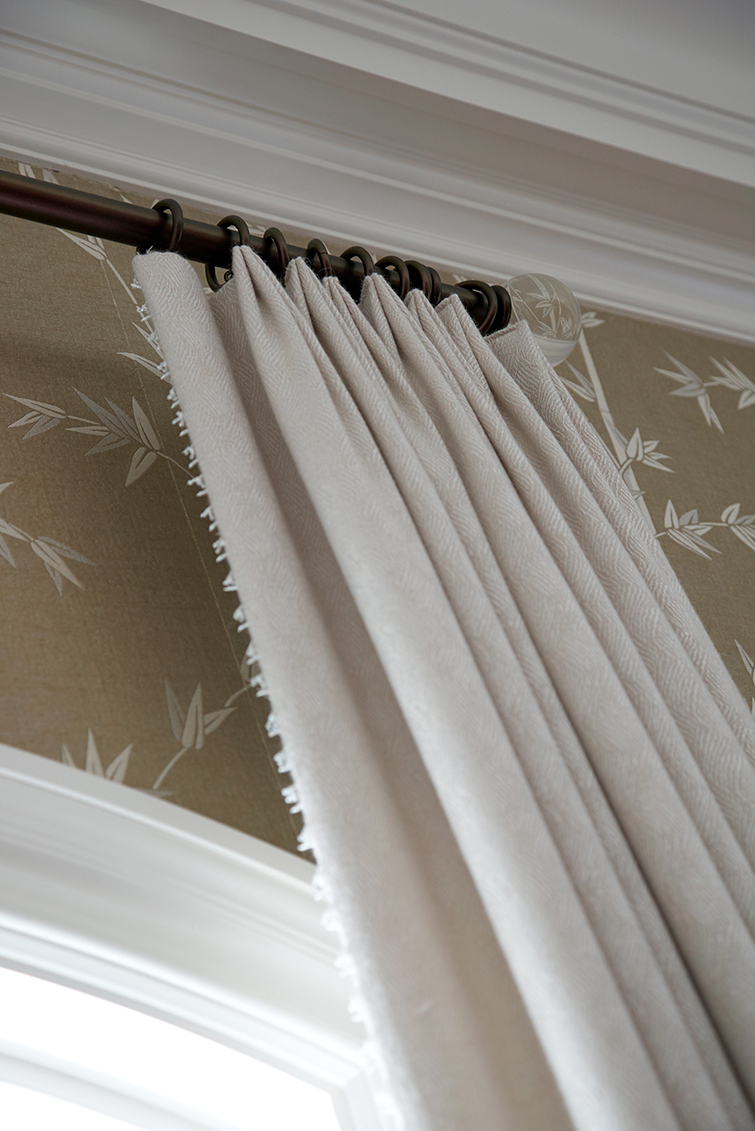 close up of natural colored drapes hung with circle fasteners