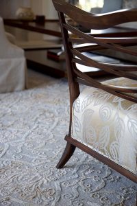 close up of criss cross wooden dining room chair back with upholstered seat