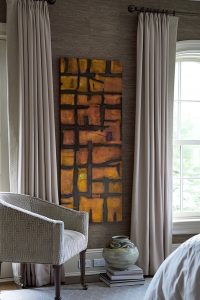 photo of bedroom window treatments and abstract art