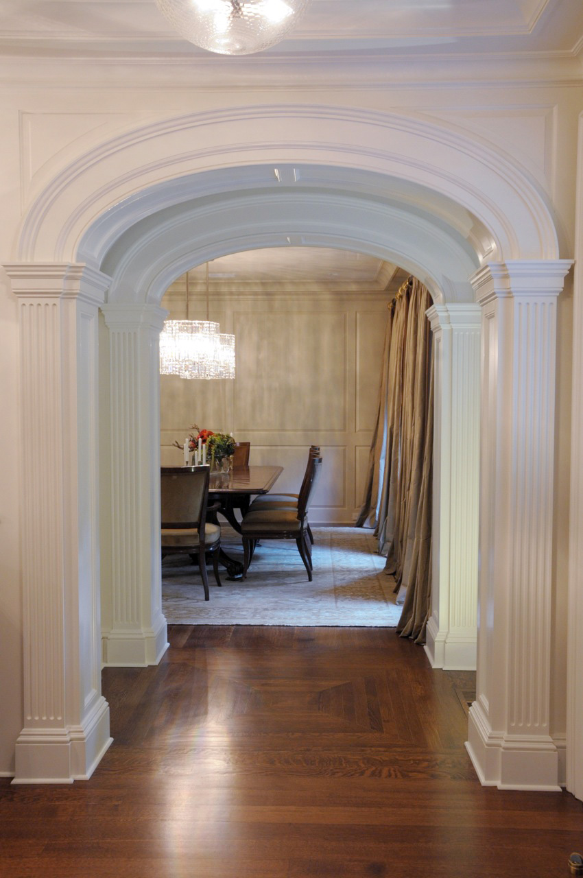 photo of archway to dining room with circular glass chandeliers