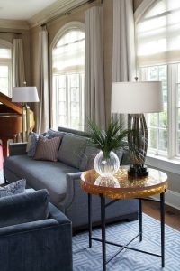 photo of living room couches and circular glass and metal end table