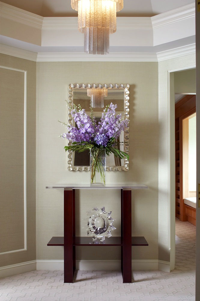 photo of entry way with metal mirror and purple flowers