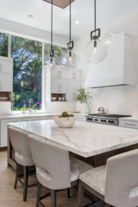 Elegant white kitchen with marble island