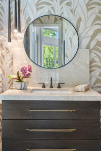 Elegant bathroom vanity with round mirror and drop pendant lights