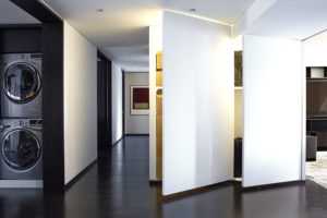 Contemporary entry with floor to ceiling invisible doors that are open