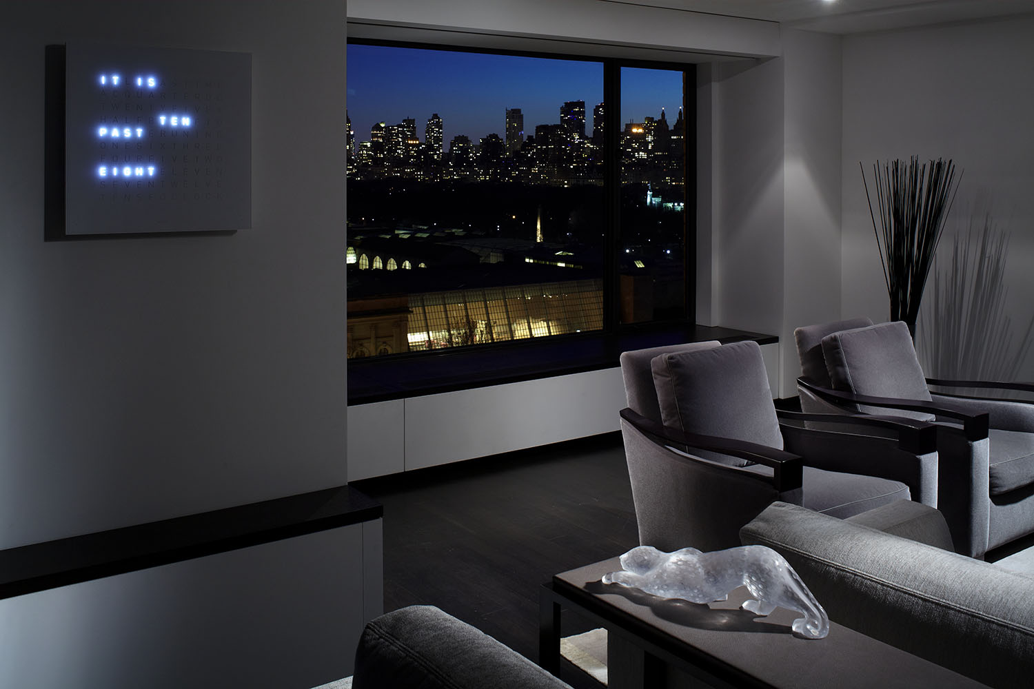 Contemporary living room design with NYC night skyline